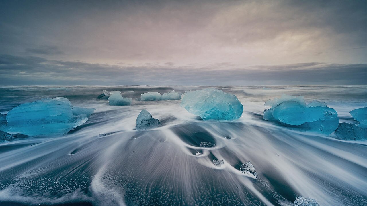 Icebergs in crystal blue waters