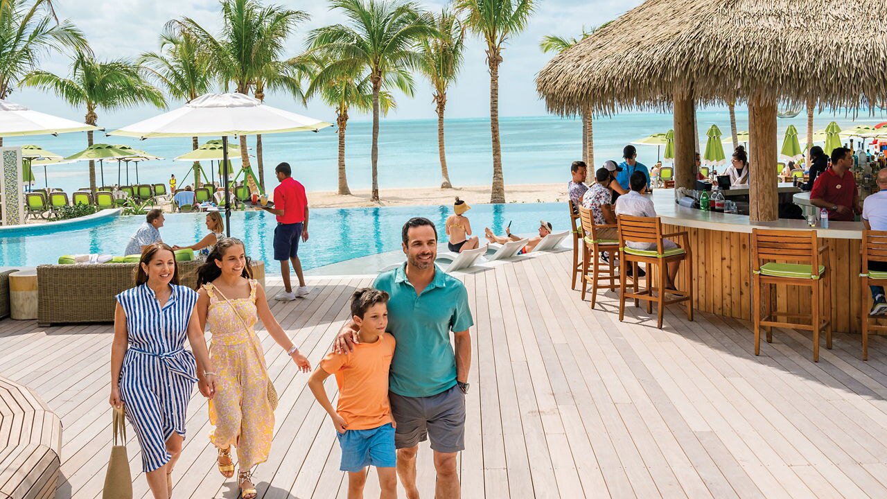 family walking in the Coco Beach Club clubhouse