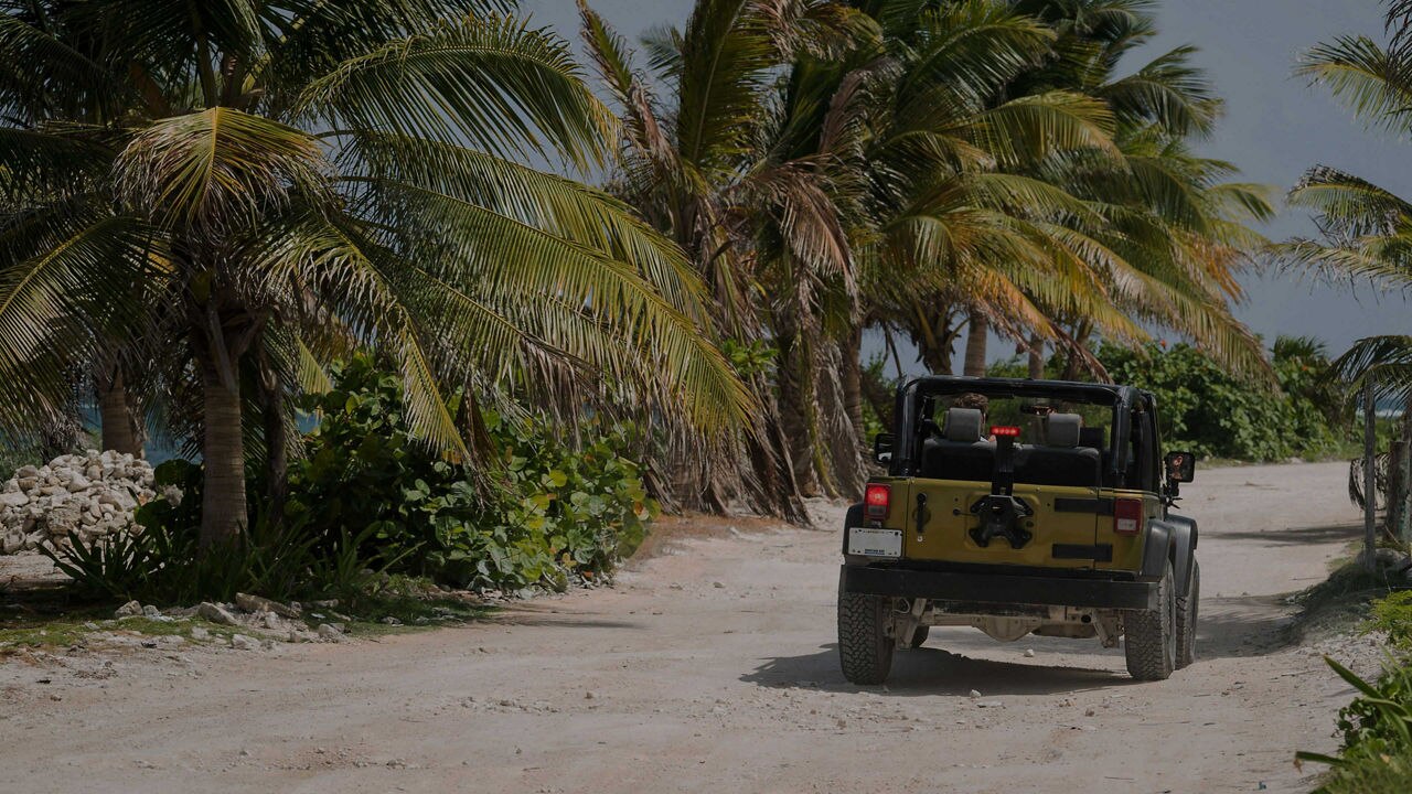 off-road jeep riding towards beach in Costa Maya